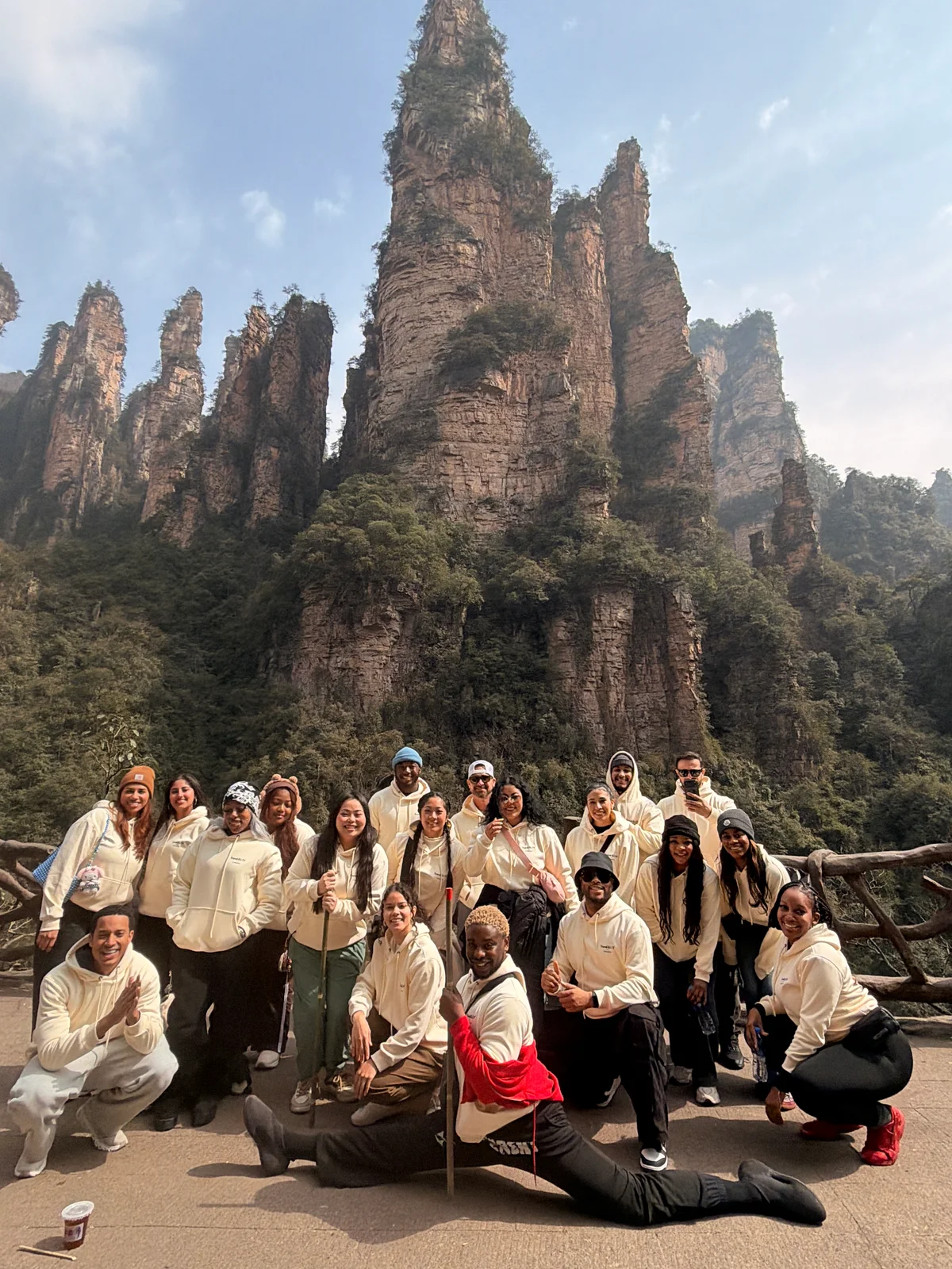 Travelers gathered in front of towering mountain peaks